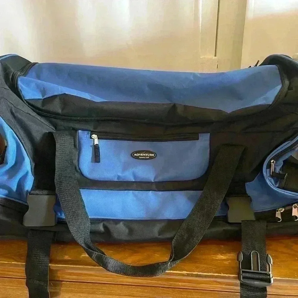 Adventure brand cargo travel‎ bag 30”L with several zipper pockets and wheels